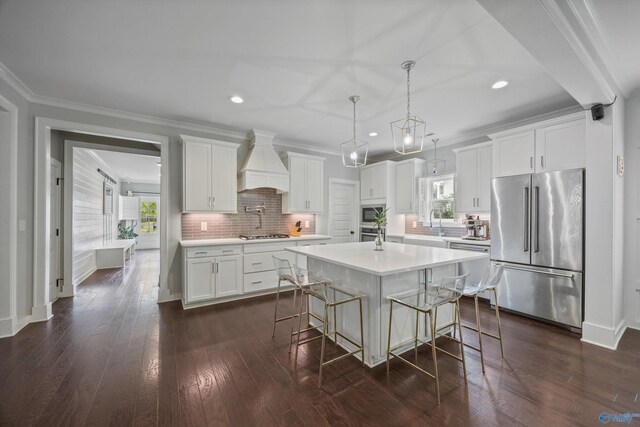 2654 Mountain Stream Way, Owens Cross Roads, AL 35763 - kitchen featuring stainless steel appliances, custom range hood, light countertops, a breakfast bar, and recessed lighting