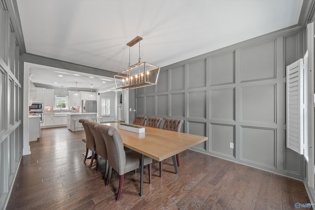 2654 Mountain Stream Way, Owens Cross Roads, AL 35763 - dining area with a decorative wall, a chandelier, and dark wood-style flooring