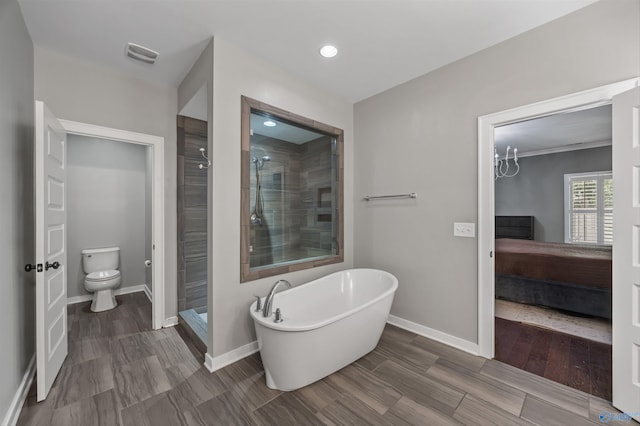 2654 Mountain Stream Way, Owens Cross Roads, AL 35763 - ensuite bathroom featuring a freestanding tub, a stall shower, recessed lighting, and wood finished floors