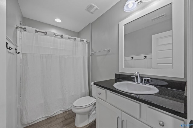 2654 Mountain Stream Way, Owens Cross Roads, AL 35763 - bathroom featuring vanity, wood finished floors, and shower / bathtub combination with curtain