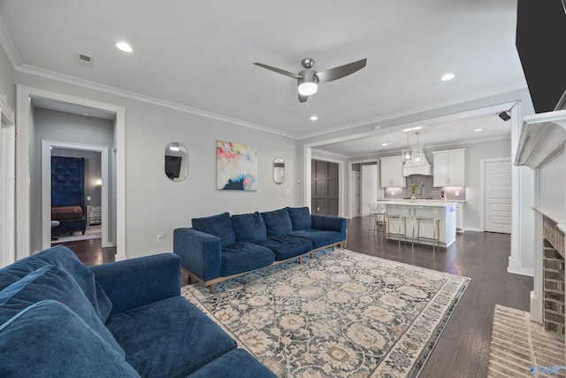 2654 Mountain Stream Way, Owens Cross Roads, AL 35763 - living room with a ceiling fan, ornamental molding, dark wood-style flooring, recessed lighting, and a fireplace