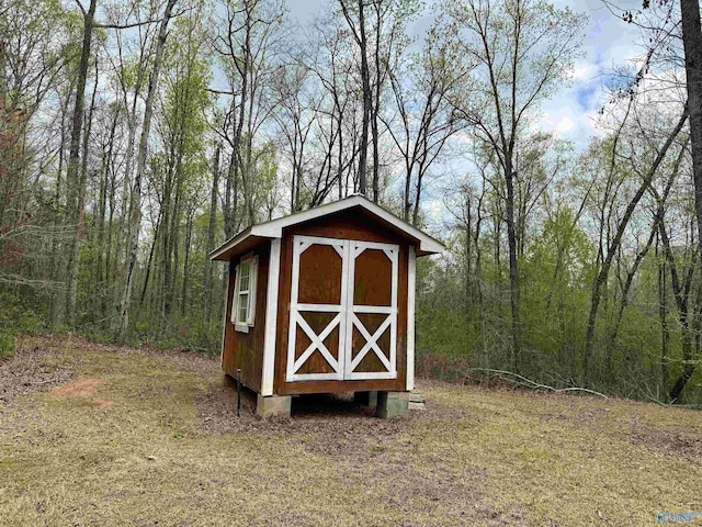 view of shed with a wooded view