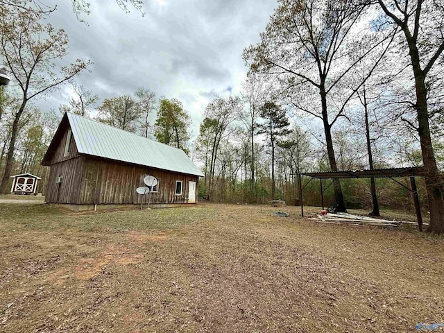 view of yard with an outdoor structure and a carport