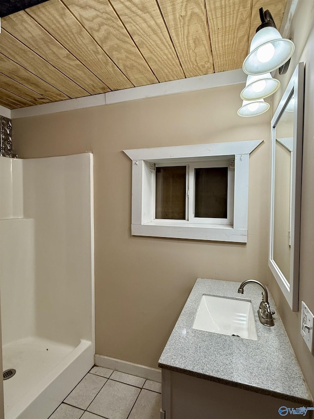 bathroom featuring tile patterned flooring, vanity, baseboards, a shower stall, and wood ceiling