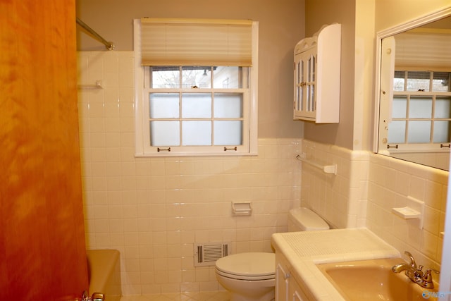 full bathroom featuring vanity, tub / shower combination, tile walls, and toilet