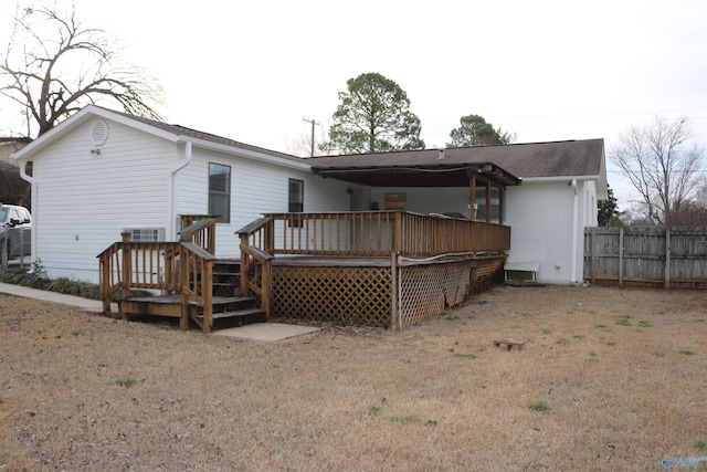 back of property featuring a yard and a deck