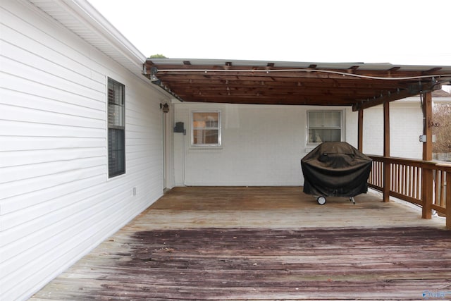 wooden deck with a grill