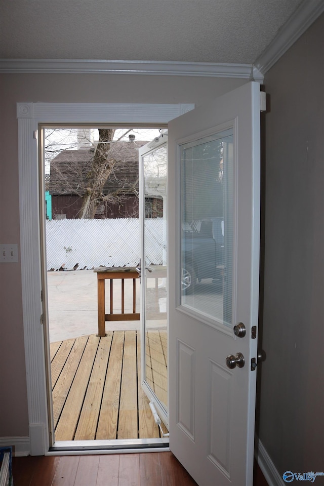 entryway featuring hardwood / wood-style flooring and ornamental molding