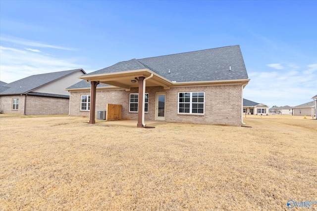 back of property with central AC and a patio area