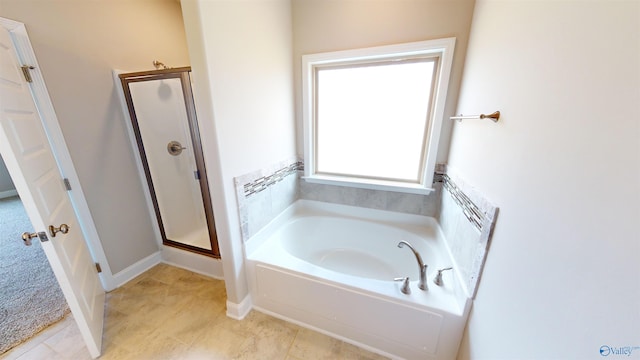 bathroom featuring shower with separate bathtub