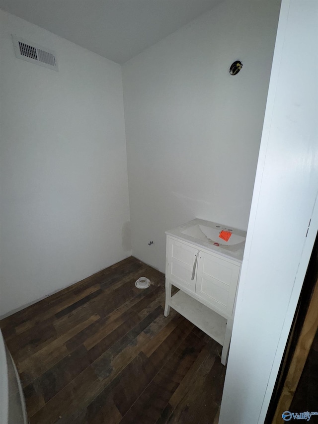 interior space with dark wood-type flooring and visible vents