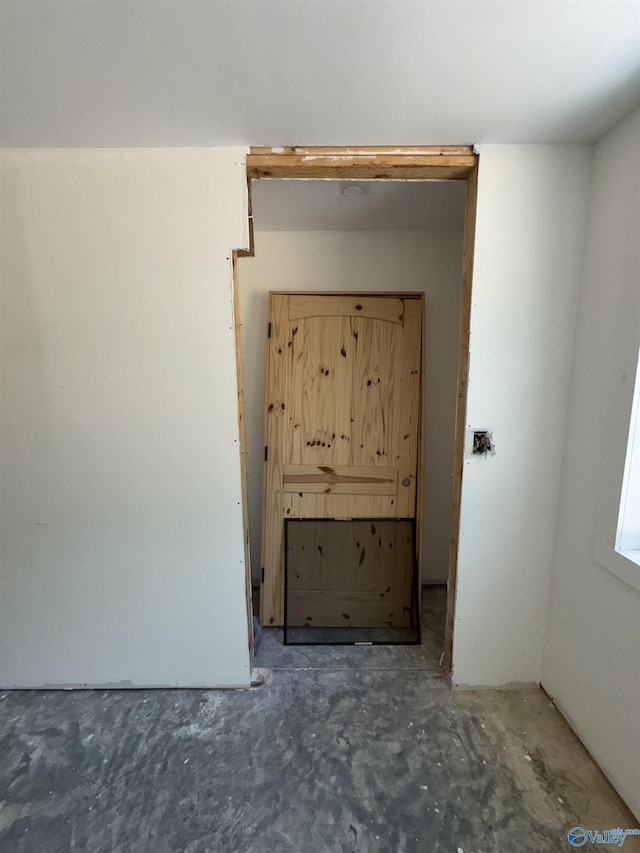 interior space featuring unfinished concrete flooring
