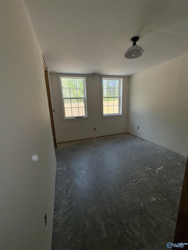 empty room featuring unfinished concrete floors