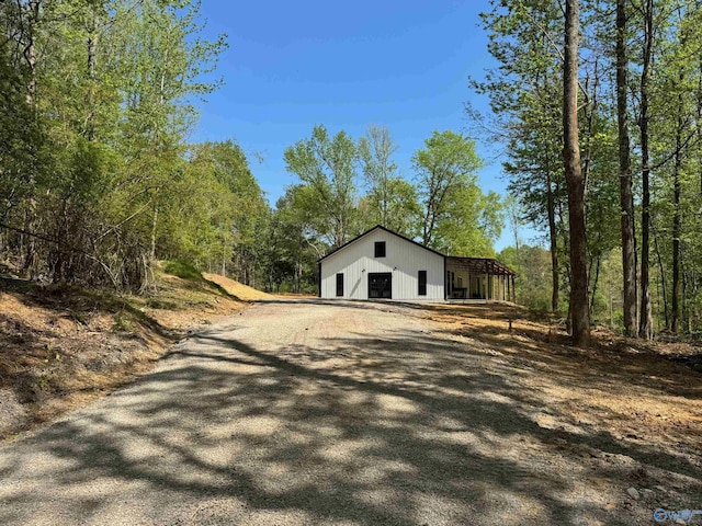 exterior space with an outbuilding, driveway, an outdoor structure, and a garage