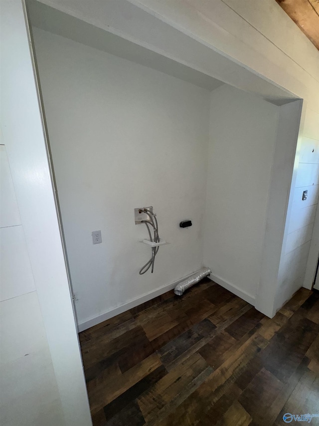 clothes washing area featuring laundry area and dark wood finished floors