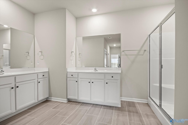 bathroom featuring walk in shower and vanity