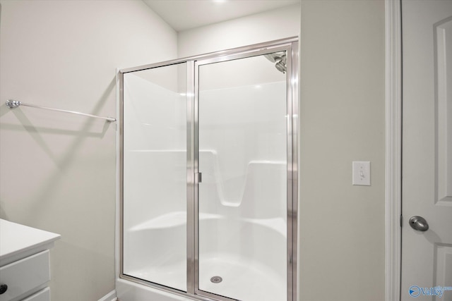 bathroom featuring vanity and a shower with shower door