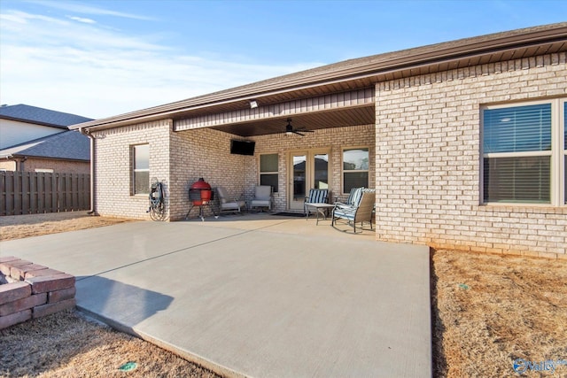 rear view of property with a patio and ceiling fan