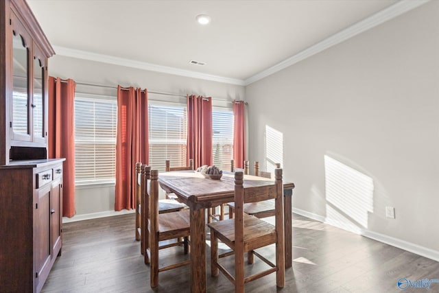 dining space with ornamental molding and dark hardwood / wood-style floors