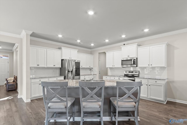 kitchen with white cabinetry, an island with sink, appliances with stainless steel finishes, and sink