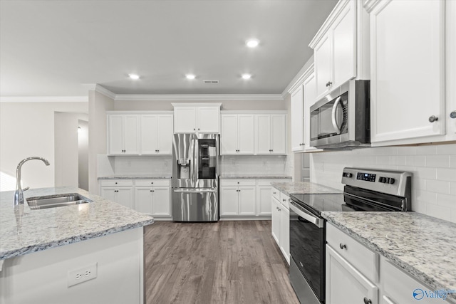 kitchen featuring sink, crown molding, appliances with stainless steel finishes, light stone countertops, and white cabinets