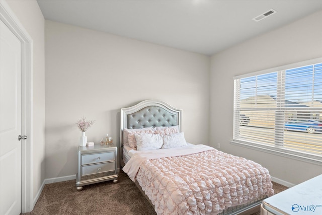 bedroom with dark colored carpet