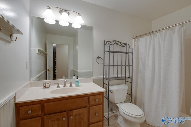 full bathroom with toilet, curtained shower, and vanity