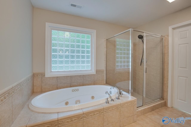 full bathroom with tile patterned flooring, a whirlpool tub, a stall shower, and visible vents