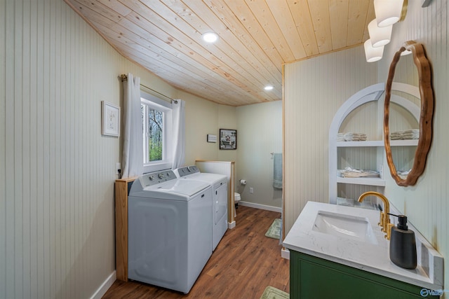 laundry room featuring baseboards, wood finished floors, a sink, washer and dryer, and wood ceiling