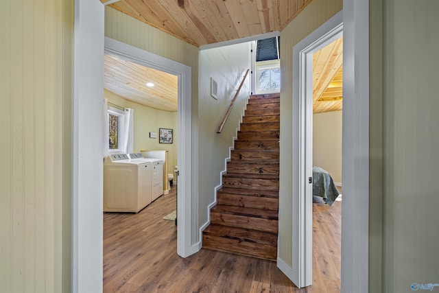 stairway featuring baseboards, washing machine and dryer, wood finished floors, and wood ceiling