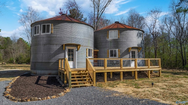 back of house with a deck