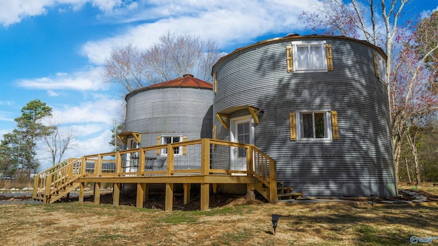 rear view of house with stairway and a deck