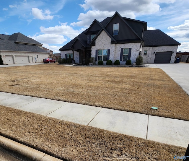 view of front of house with a garage, a front lawn, board and batten siding, and brick siding