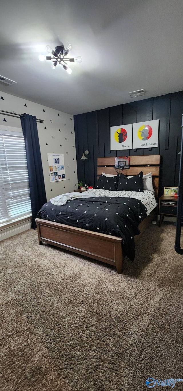 carpeted bedroom featuring visible vents