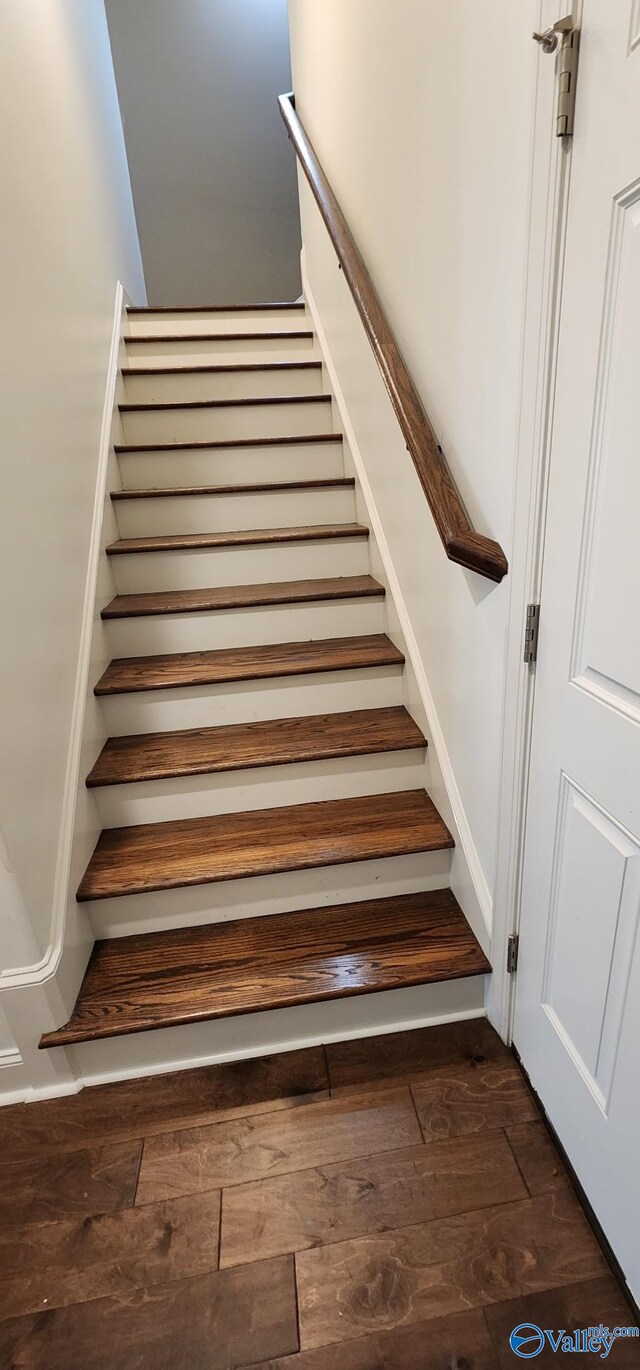 stairway featuring wood-type flooring