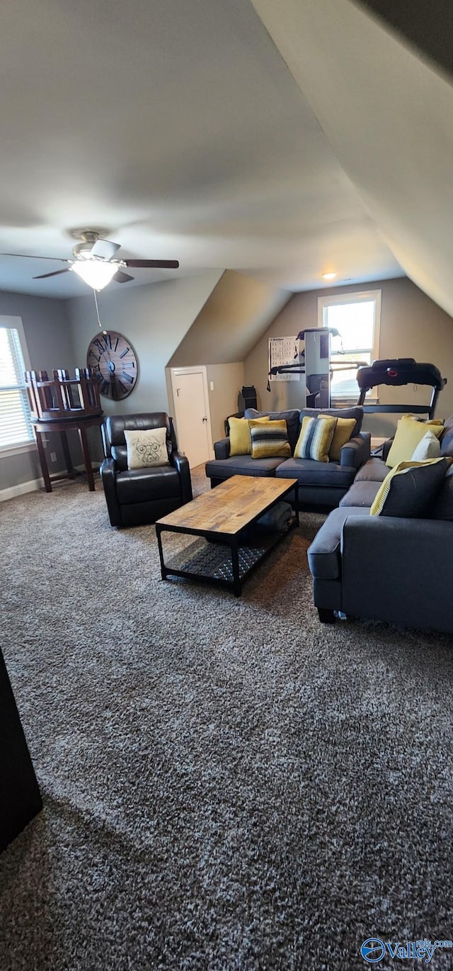 living room featuring carpet floors, ceiling fan, vaulted ceiling, and a wealth of natural light