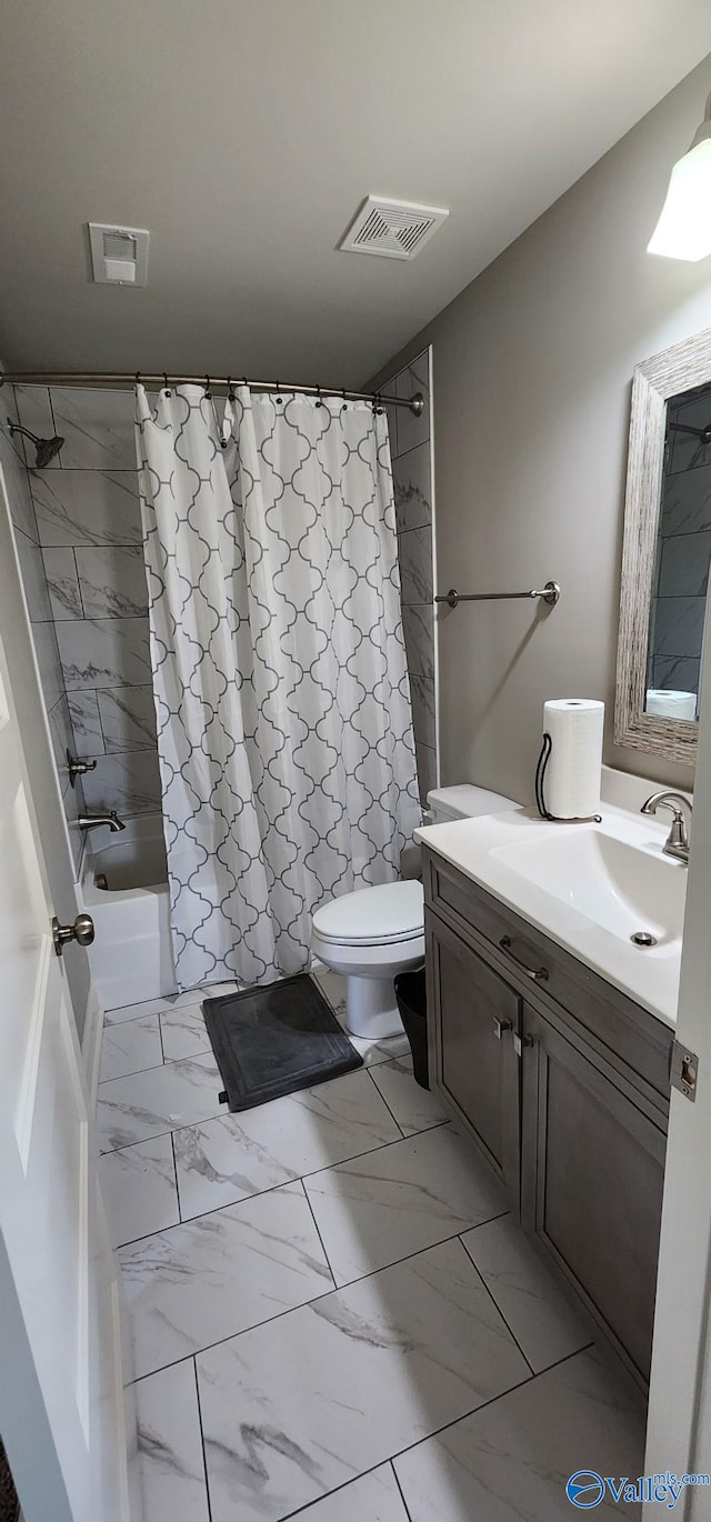 full bathroom featuring toilet, marble finish floor, vanity, and visible vents