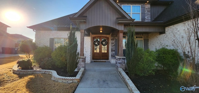 property entrance with french doors and brick siding