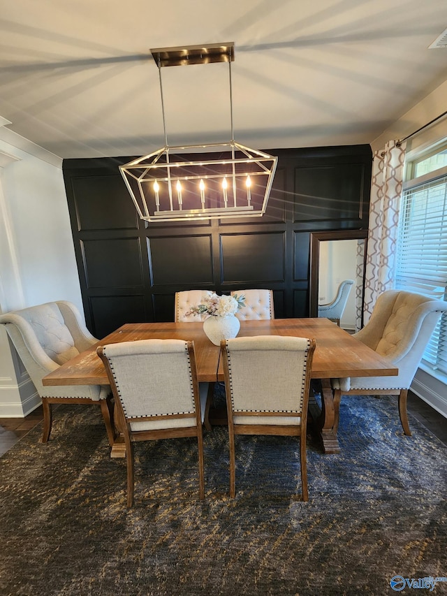 dining area featuring a decorative wall