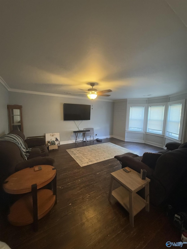 living room with ornamental molding, ceiling fan, and dark wood-type flooring