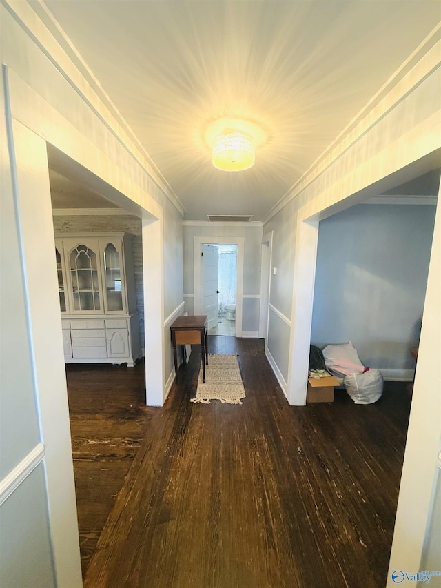 hall featuring dark hardwood / wood-style flooring and ornamental molding