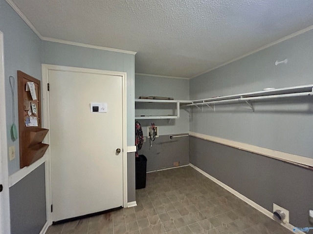 laundry room with ornamental molding and a textured ceiling