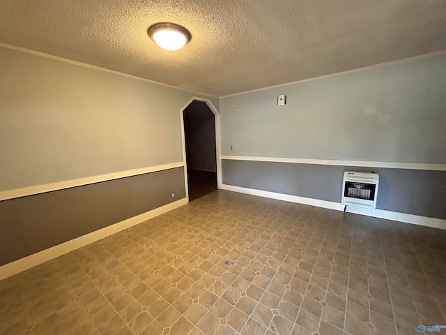 unfurnished room with a textured ceiling and heating unit