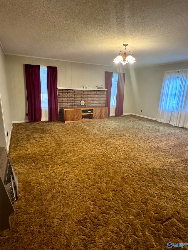 interior space featuring a fireplace, a textured ceiling, and a notable chandelier