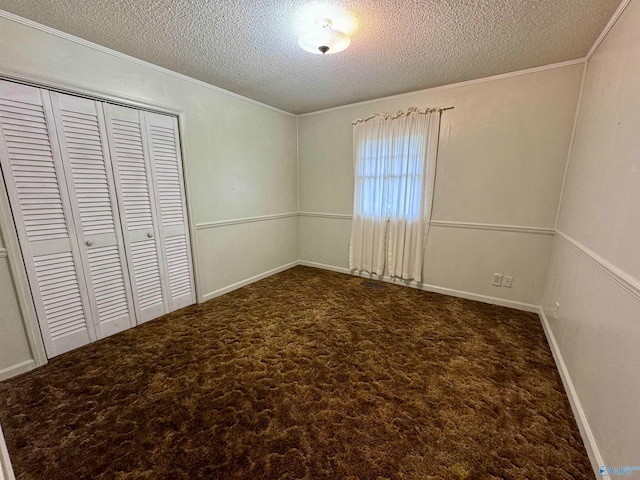 unfurnished bedroom with a closet, a textured ceiling, and carpet flooring