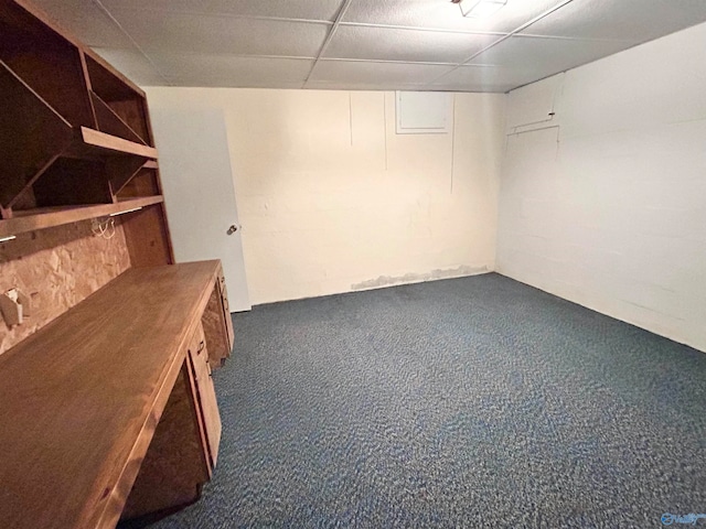 basement with dark carpet and a drop ceiling