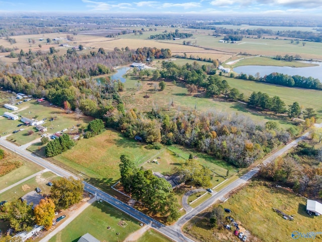 birds eye view of property featuring a water view and a rural view