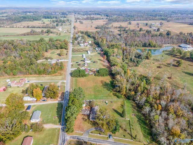 birds eye view of property featuring a water view and a rural view