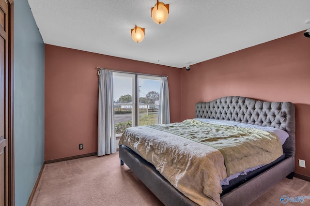 bedroom with a textured ceiling and light carpet