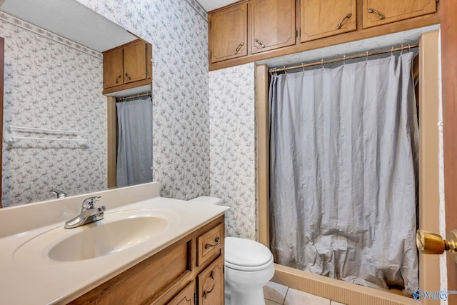 bathroom featuring tile patterned flooring, vanity, and toilet